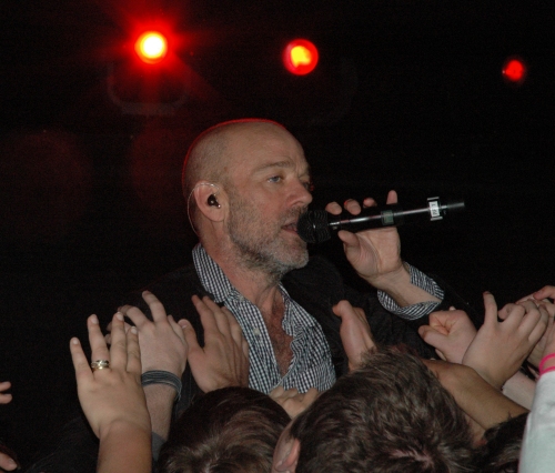 Lots of hands try and grab Michael Stipe. Manchester (2008)