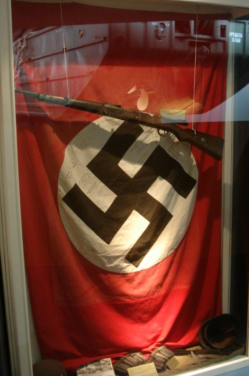 An authentic Nazis flag and rifle, the flag is signed, France (2006)